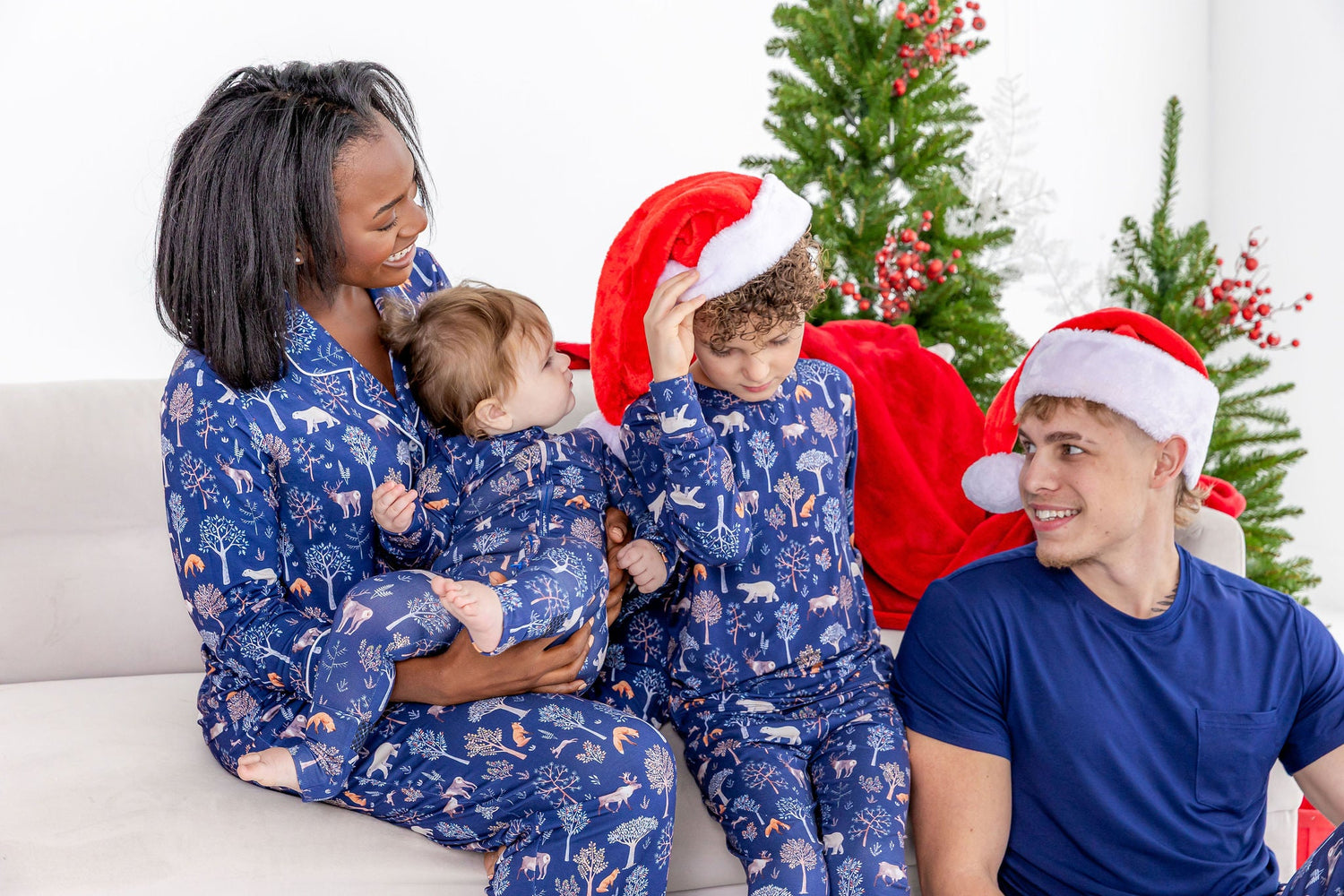 Family wearing matching family pajamas in cozy woodland print