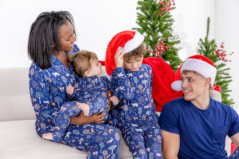 Family wearing matching family pajamas in cozy woodland print