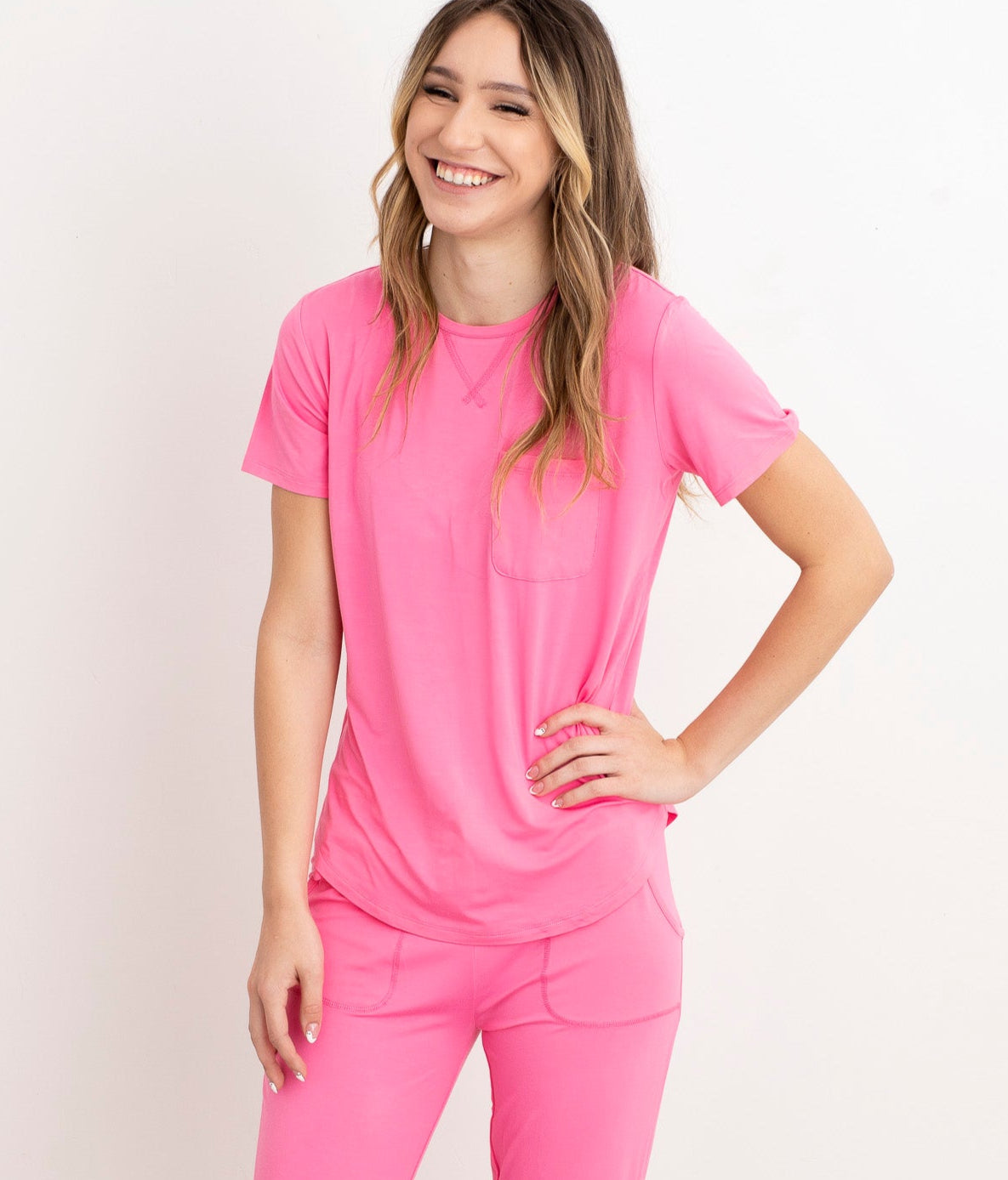 Woman wearing a pink pajama set on a white background