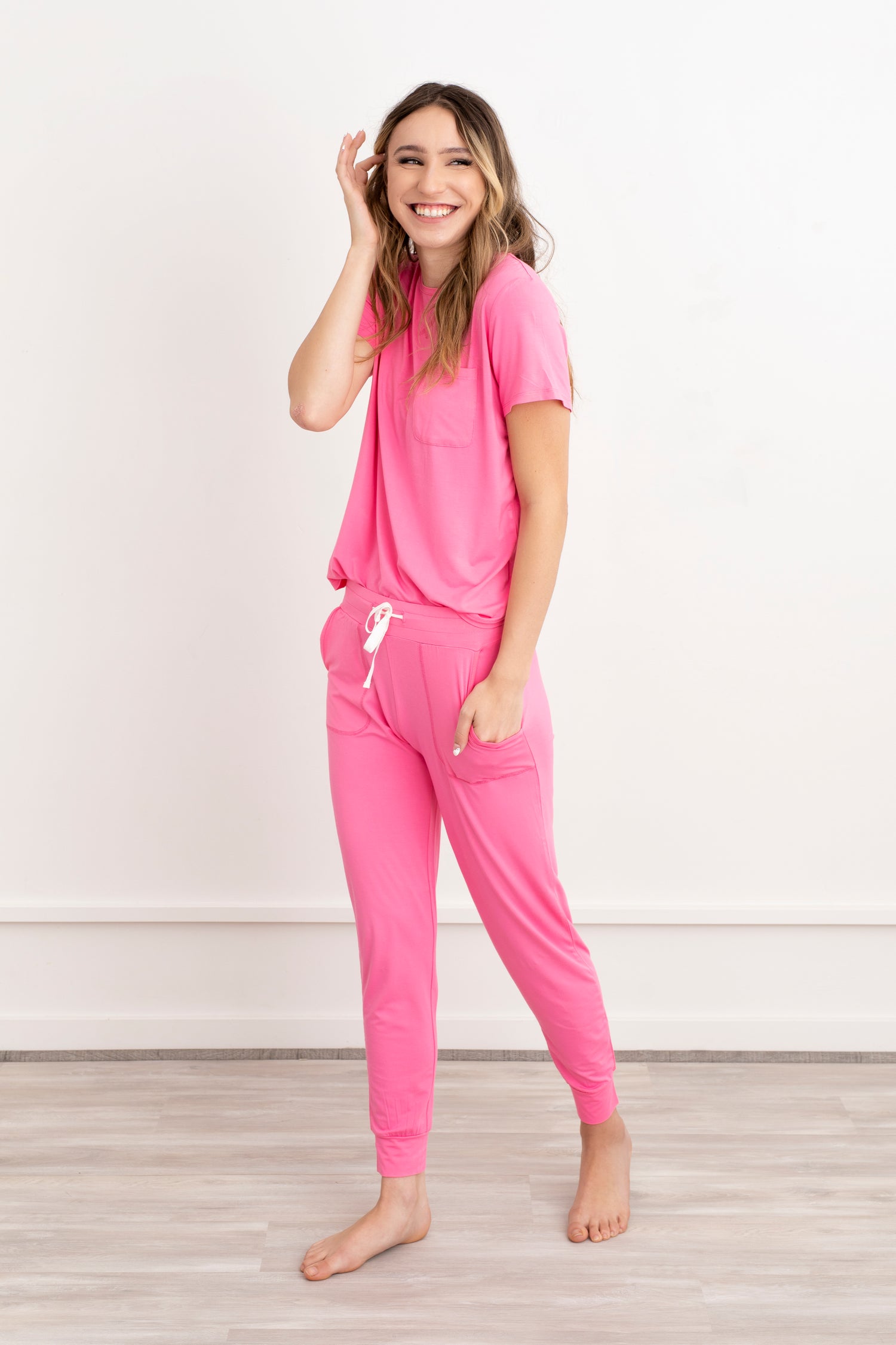 Front view of model wearing bamboo women pajama set in blush pink with jogger pants