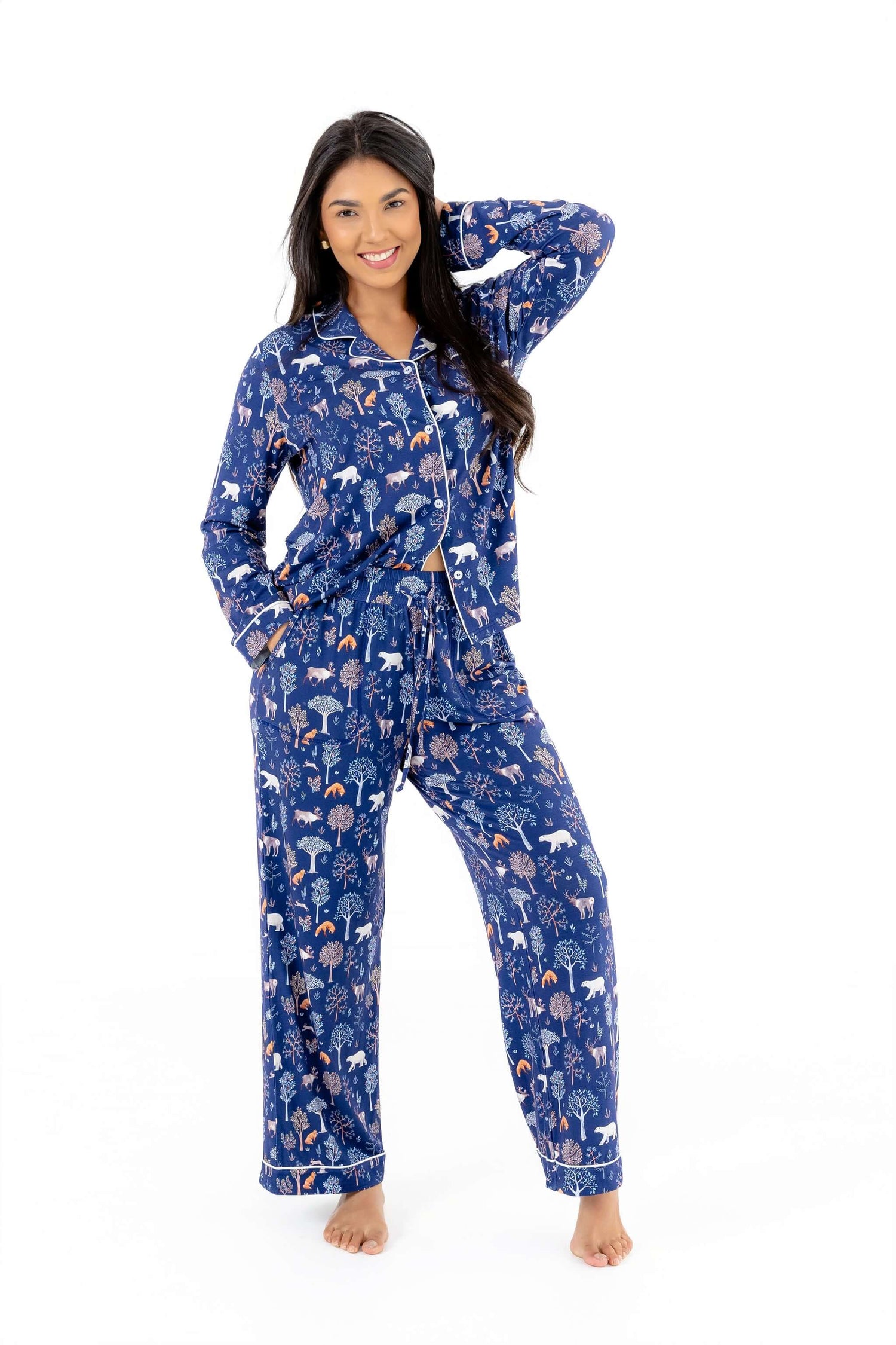 Woman wearing a blue pajama set with animal pattern on a white background