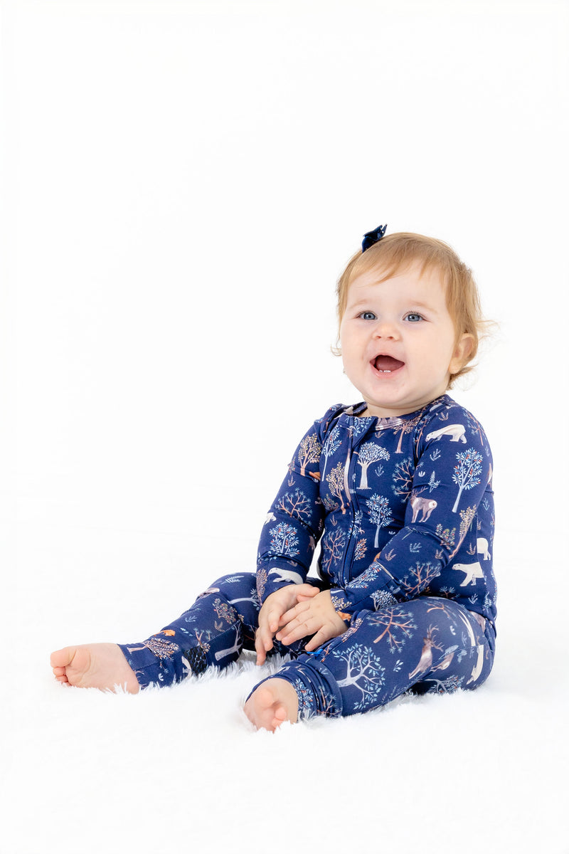 Baby girl sitting in baby modal convertible romper pajama – Woodland Night print